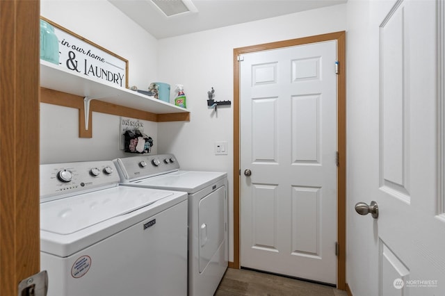 laundry room with hardwood / wood-style flooring and washing machine and dryer