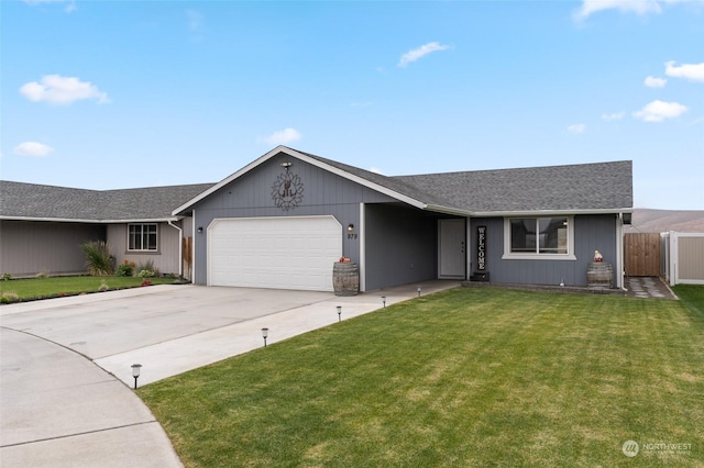 ranch-style house featuring a garage and a front lawn