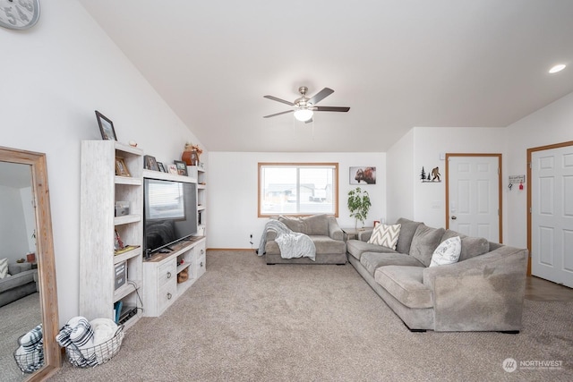 carpeted living room featuring vaulted ceiling and ceiling fan