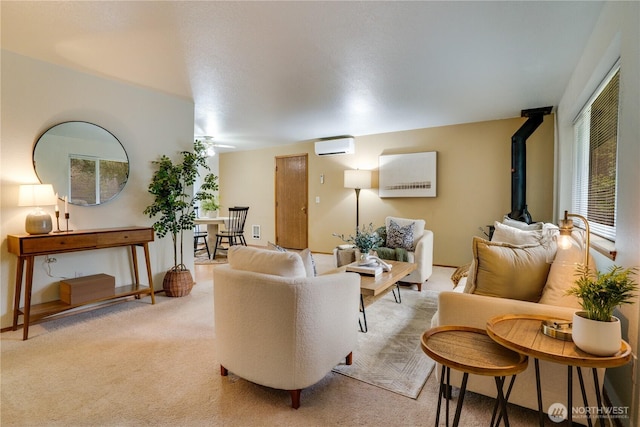 living room with light colored carpet, a wall mounted AC, and a wood stove