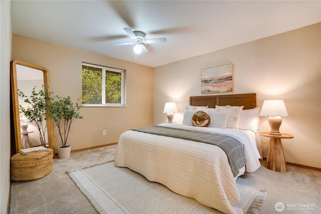 bedroom featuring baseboards, a ceiling fan, and light colored carpet