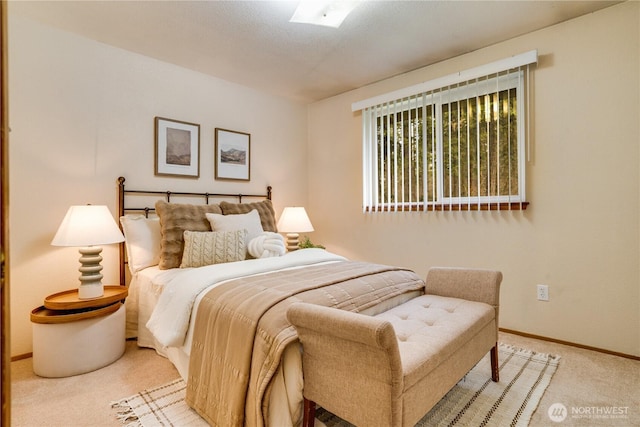 carpeted bedroom featuring baseboards