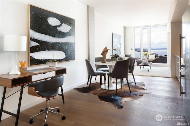 interior space featuring wood-type flooring and floor to ceiling windows