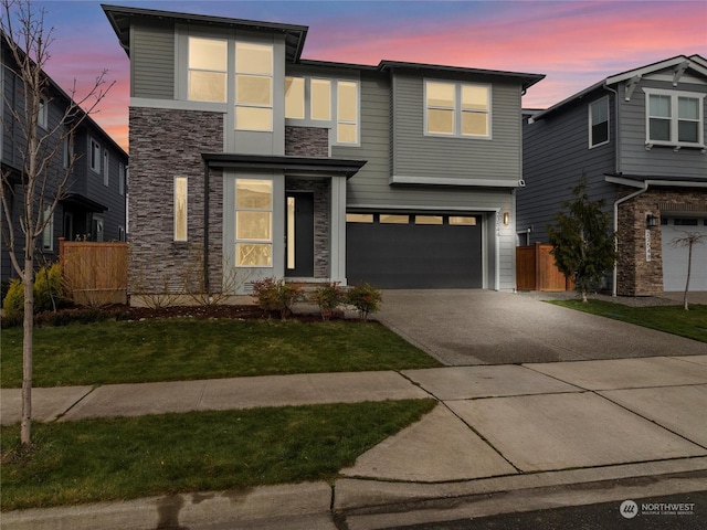 view of front of house featuring a garage and a yard