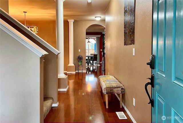 foyer entrance with dark hardwood / wood-style floors and a notable chandelier