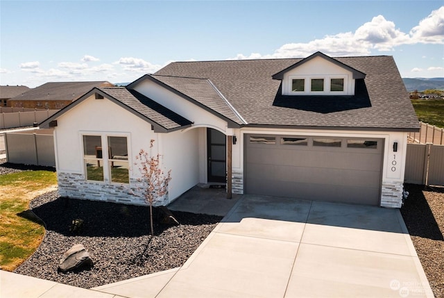 view of front of home with an attached garage, a shingled roof, fence, stucco siding, and driveway