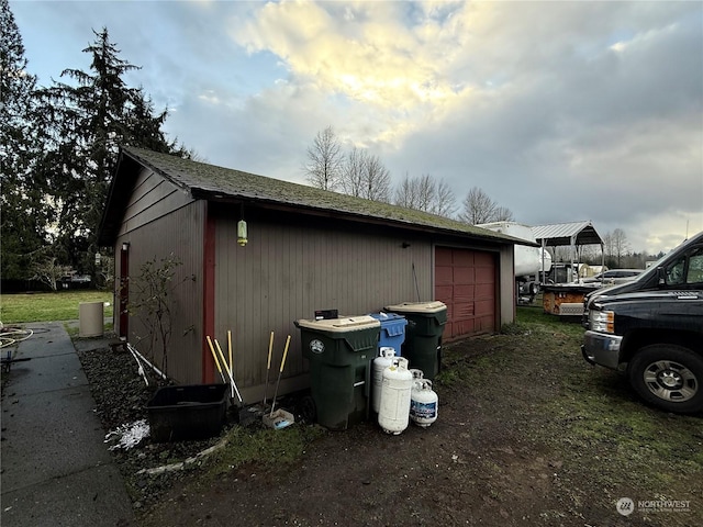 view of home's exterior featuring an outbuilding and a garage