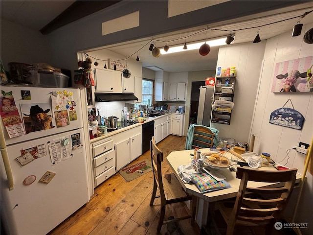 kitchen with white cabinetry, sink, rail lighting, white refrigerator, and light hardwood / wood-style floors