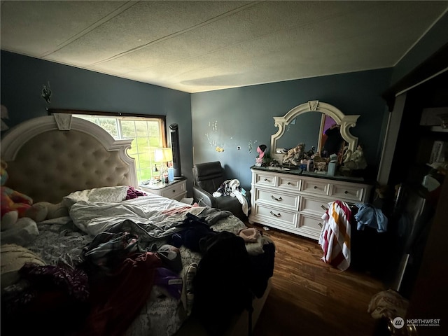 bedroom with dark wood-type flooring