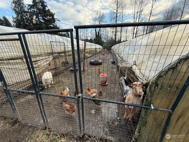 view of gate with an outbuilding