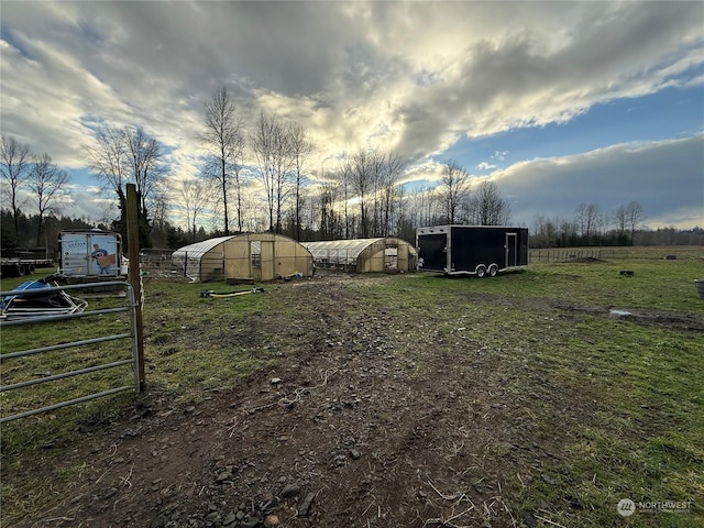 view of yard with an outbuilding and a rural view