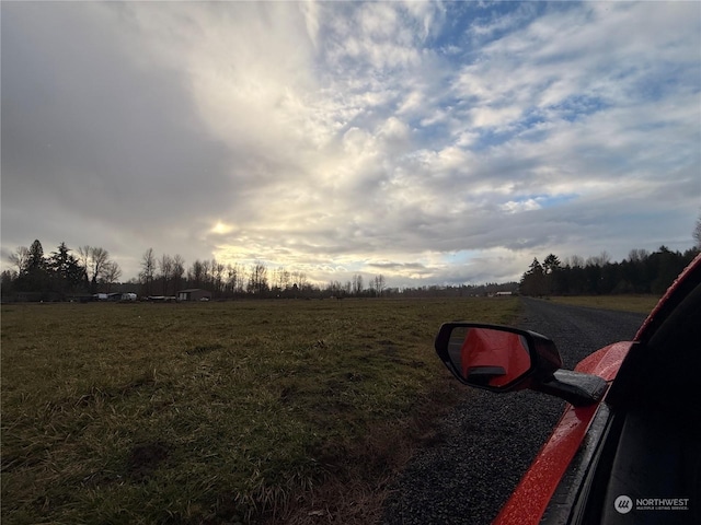 yard at dusk with a rural view