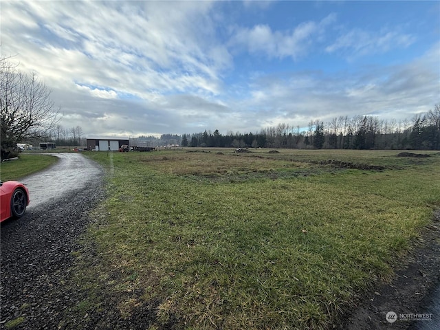 view of yard with a rural view