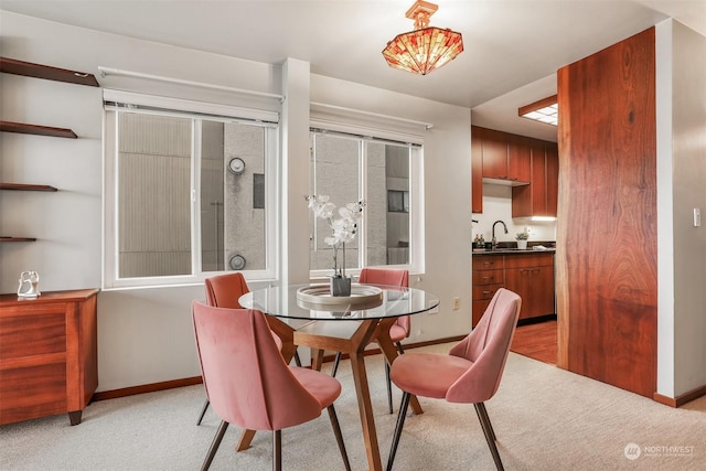 carpeted dining room with sink