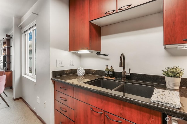 kitchen featuring sink and dark stone counters