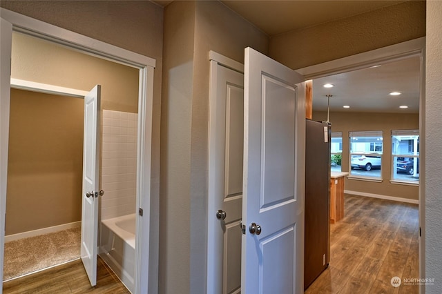 hallway with hardwood / wood-style flooring