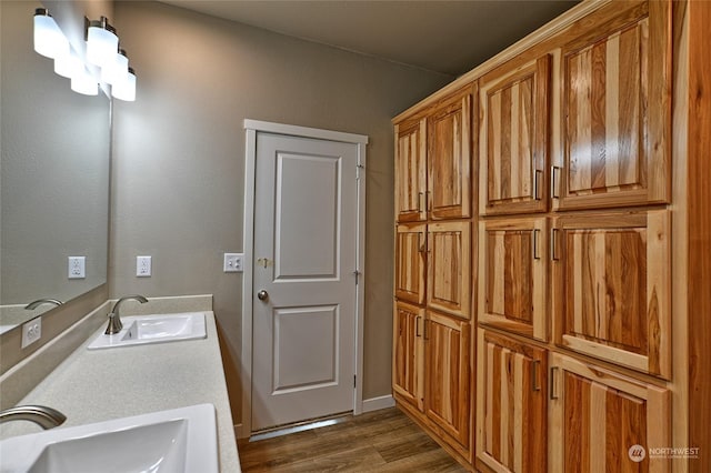 laundry area featuring dark wood-type flooring and sink