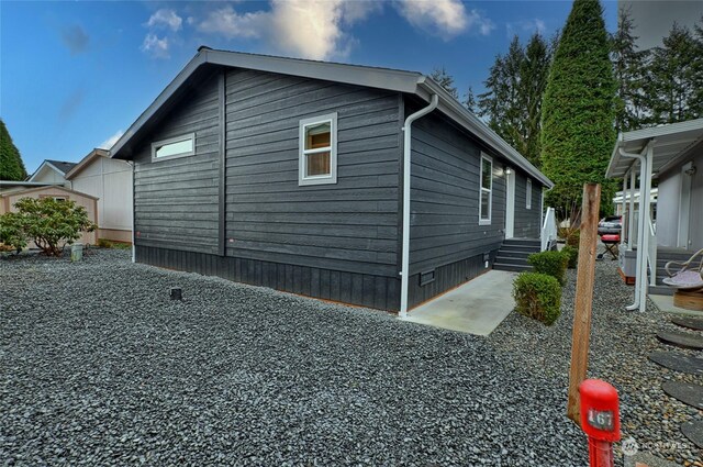 view of side of home featuring a patio area