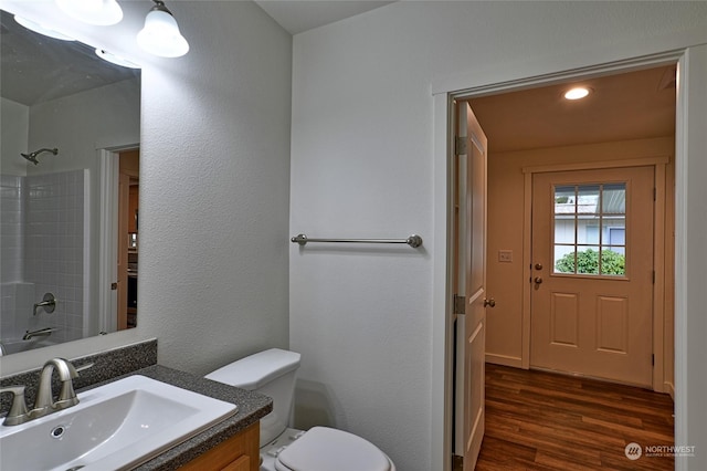 full bathroom featuring hardwood / wood-style flooring, vanity, toilet, and shower / bathing tub combination