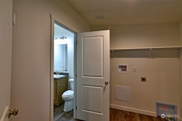 laundry room with hookup for an electric dryer, sink, dark wood-type flooring, and hookup for a washing machine