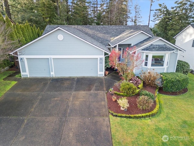 view of front of house with a garage and a front lawn