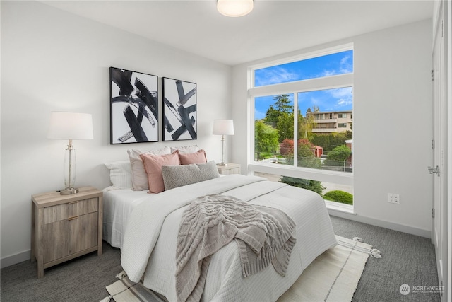 carpeted bedroom featuring baseboards