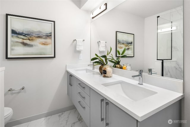 full bathroom featuring double vanity, marble finish floor, baseboards, and a sink