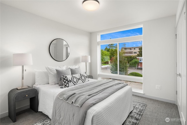 bedroom featuring carpet floors and baseboards