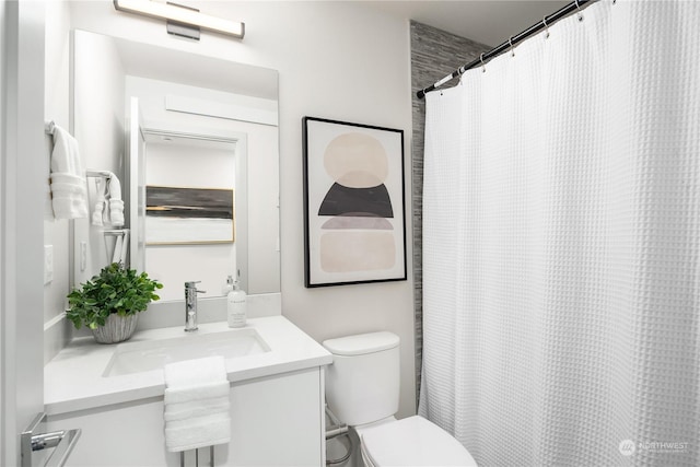 bathroom featuring toilet and vanity