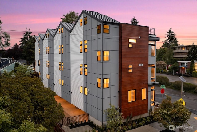 view of home's exterior featuring a standing seam roof and metal roof