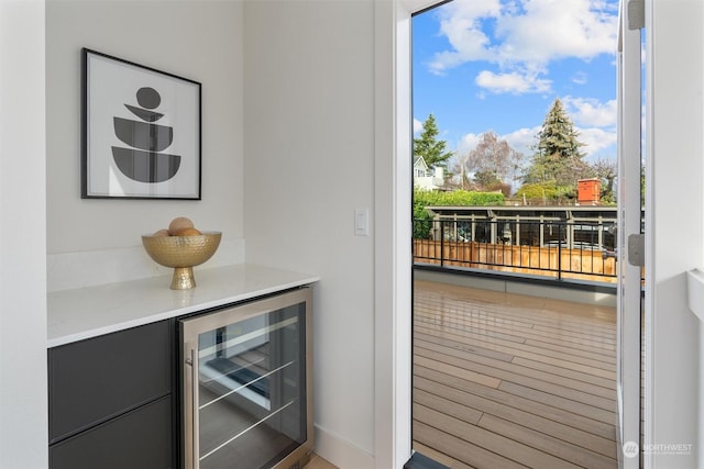 doorway to outside featuring bar area and beverage cooler