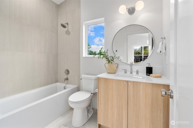 full bathroom with vanity, toilet, tiled shower / bath, and a healthy amount of sunlight