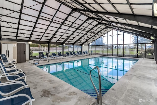 view of swimming pool with a lanai and a patio