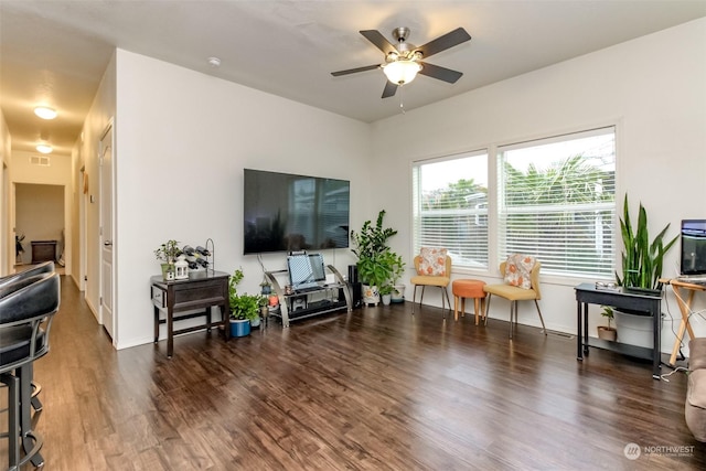 living room with ceiling fan and dark hardwood / wood-style flooring