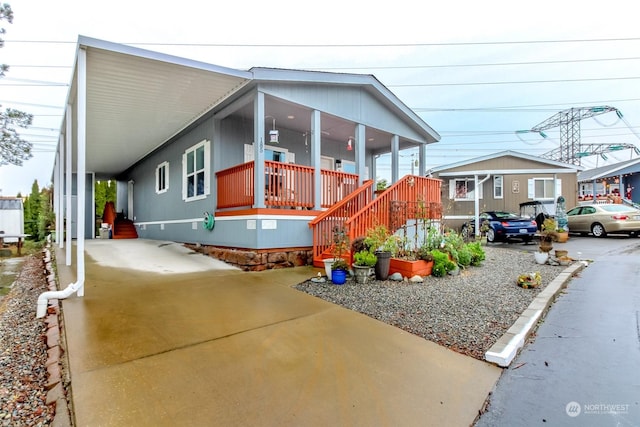 manufactured / mobile home with a sunroom and a carport