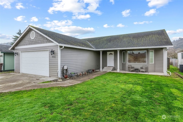 ranch-style home featuring a garage and a front lawn