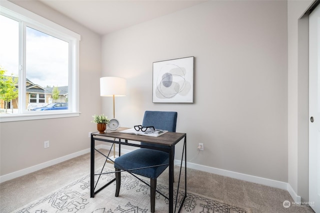 home office featuring light carpet and baseboards