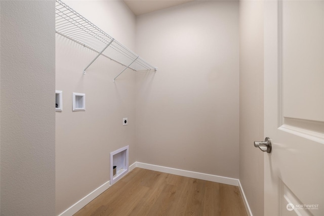 washroom featuring laundry area, baseboards, light wood-style flooring, hookup for a washing machine, and hookup for an electric dryer