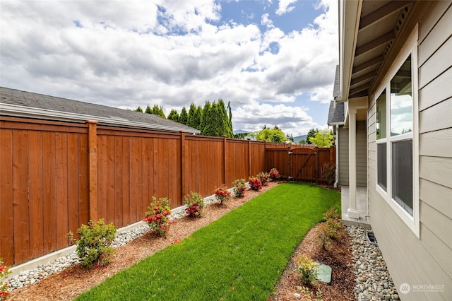 view of yard with a gate and a fenced backyard