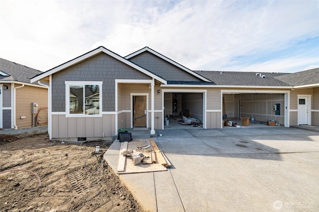 view of front of home featuring driveway, a shingled roof, crawl space, an attached garage, and board and batten siding