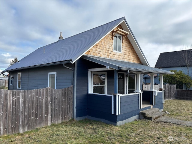 exterior space featuring covered porch and a lawn