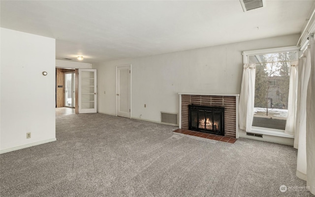 unfurnished living room with carpet floors and a brick fireplace