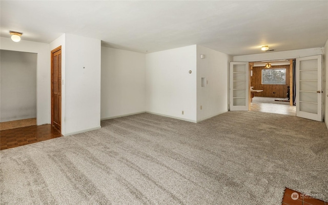 unfurnished living room with carpet flooring and french doors