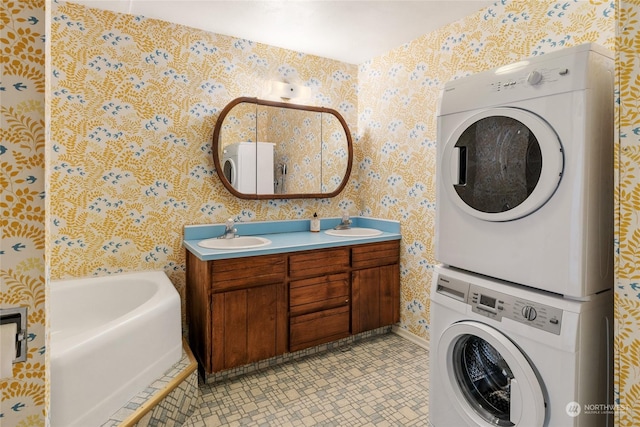 laundry area featuring stacked washer and dryer and sink