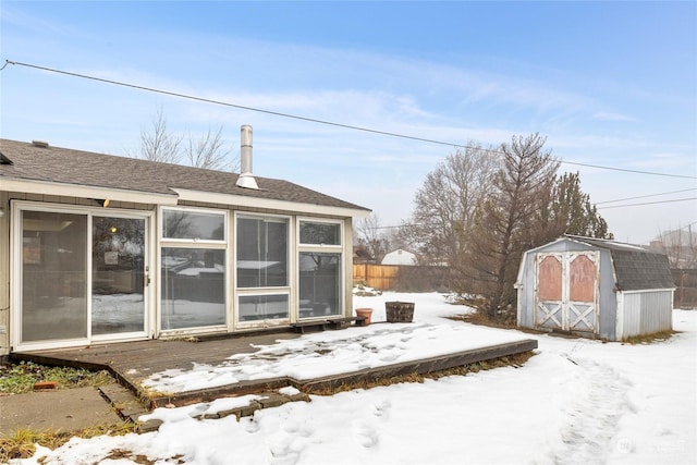 view of snow covered exterior with a storage unit