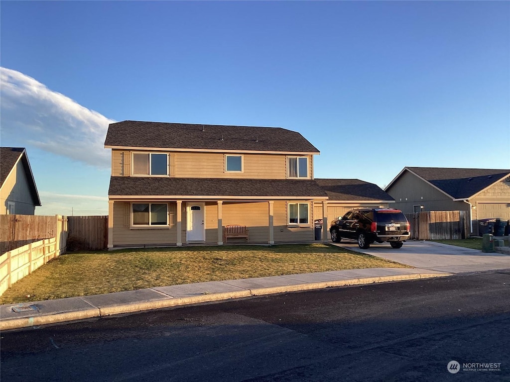 view of front of house with a porch and a front lawn