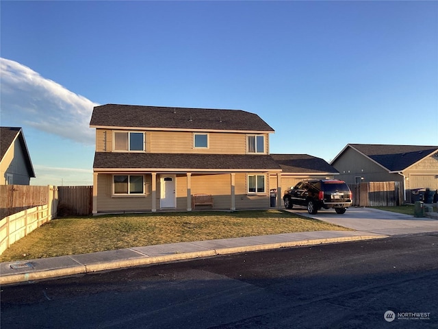 view of front of house with a porch and a front lawn