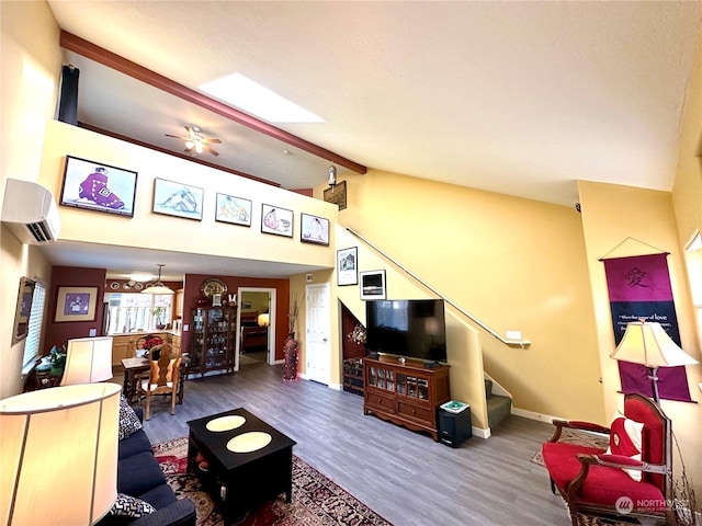 living room with ceiling fan, lofted ceiling with beams, and hardwood / wood-style flooring