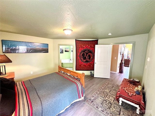 bedroom featuring a textured ceiling and hardwood / wood-style flooring