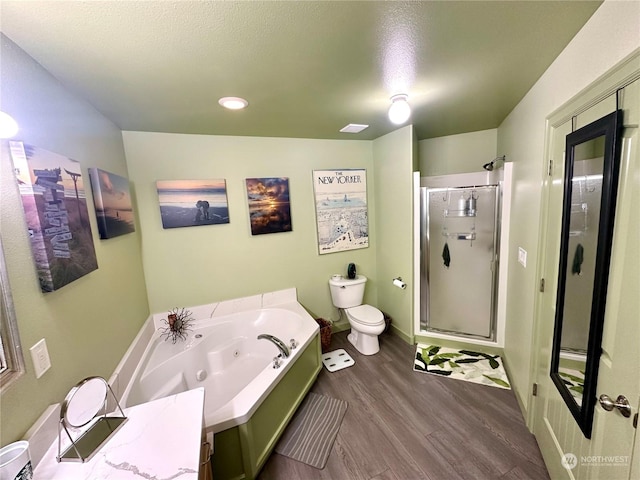 bathroom with hardwood / wood-style flooring, independent shower and bath, a textured ceiling, and toilet